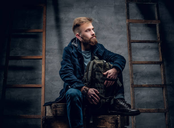 istock The bearded backpacker male sits on a wooden box. 960497776