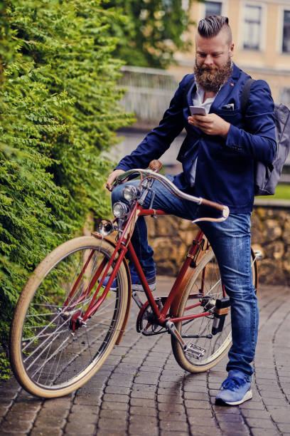 istock Bearded male in a park talks by smart phone. 960501120