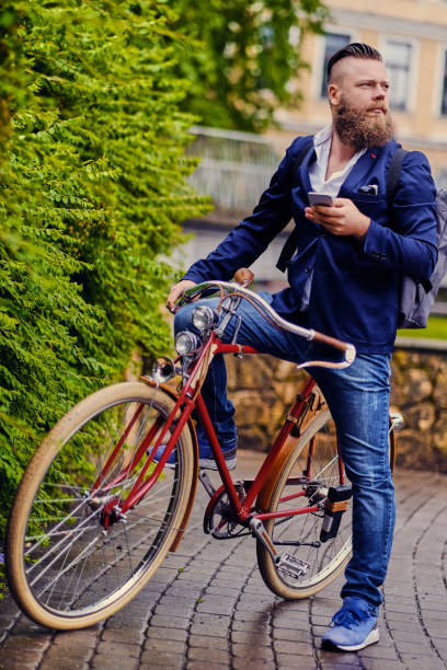 istock Bearded male in a park talks by smart phone. 960502064