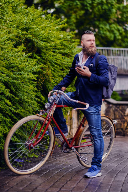 istock Bearded male in a park talks by smart phone. 960505512