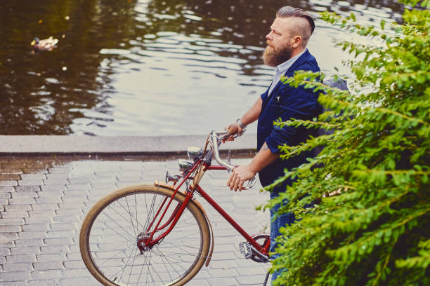 istock A man on a retro bicycle in a park. 960505720