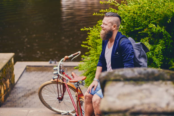 istock Redhead bearded male on a retro bicycle in a park. 960506112