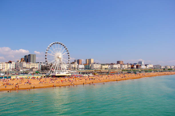 Panoramic view of Brighton Beach Panoramic view of Brighton Beach. Brighton wheel and hotels. Crowded with people on sunny day. east sussex photos stock pictures, royalty-free photos & images