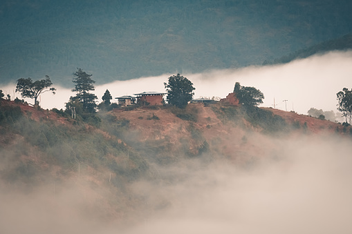 bhutan buildings early in the morning with mist