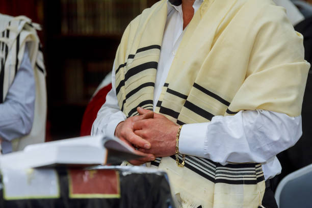 A religious orthodox Jews pray at the prayer book in synagogue