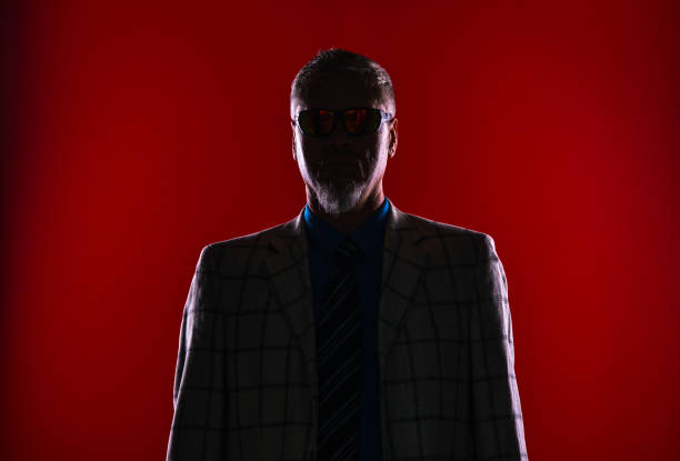 istock shadow male portrait, dark red background 960520804