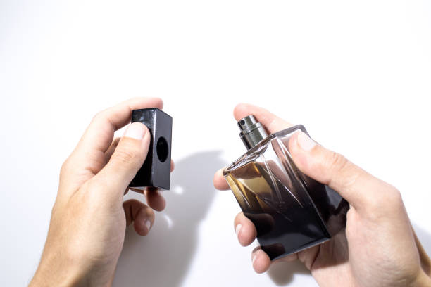 istock A person is using a detailed perfume bottle isolated in a white background composition 960527498