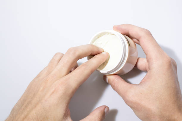 istock Jar full of beauty cream during application isolated in a white background composition 960527526
