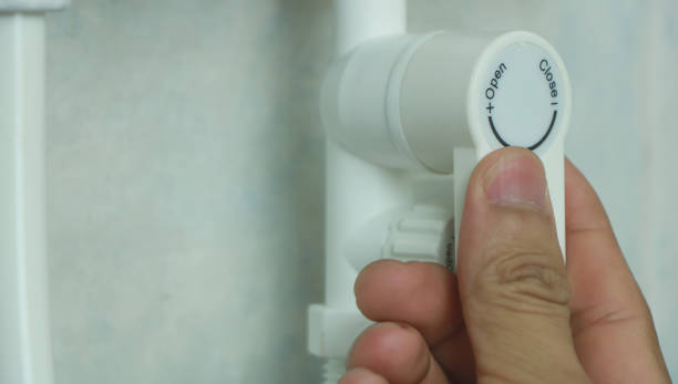 istock close-up.hand shut off the main valve 960530482