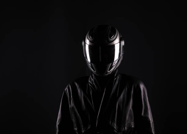 istock biker in helmet on a black background 960531234