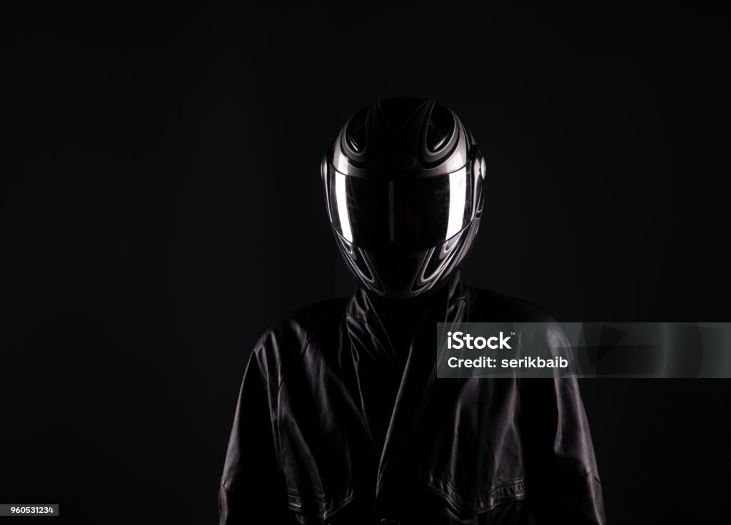 biker in helmet on a black background Crash Helmet Stock Photo