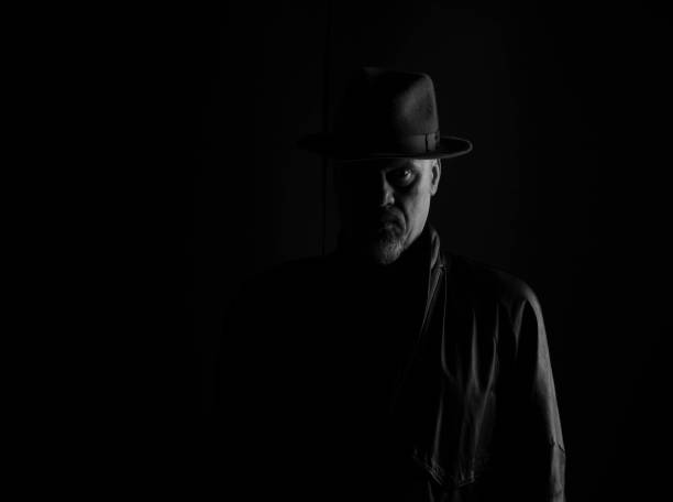 istock shadow portrait of a man, dark studio background 960531592