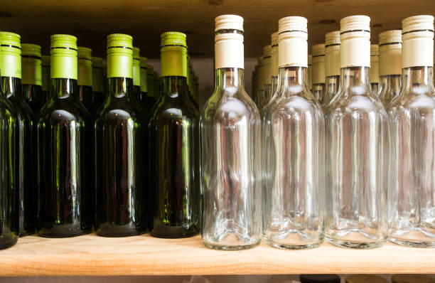 istock Background wall from empty bottles of wine on wooden shelve 960532274