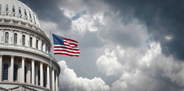 US Capitol and waving american flag Panoramic view of the United States Capitol and waving american flag in Washington DC government building photos stock pictures, royalty-free photos & images