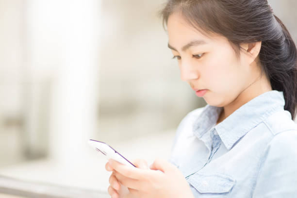 istock Young girl operating mobile phone 960532680