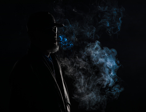 dark portrait, smoking man, black studio background