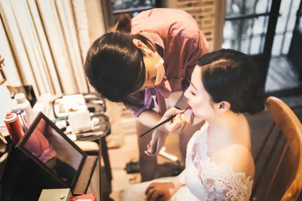 Photo of Wedding makeup artist making a make up for bride