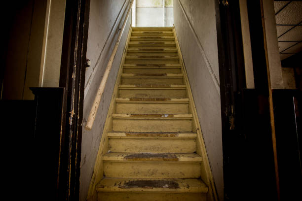 Old dirty damaged abandoned wooden stairs to the garret. Entrance to the attic. Old dirty damaged abandoned wooden stairs to the garret. Entrance to the attic. in the dark interior of old house garret stock pictures, royalty-free photos & images