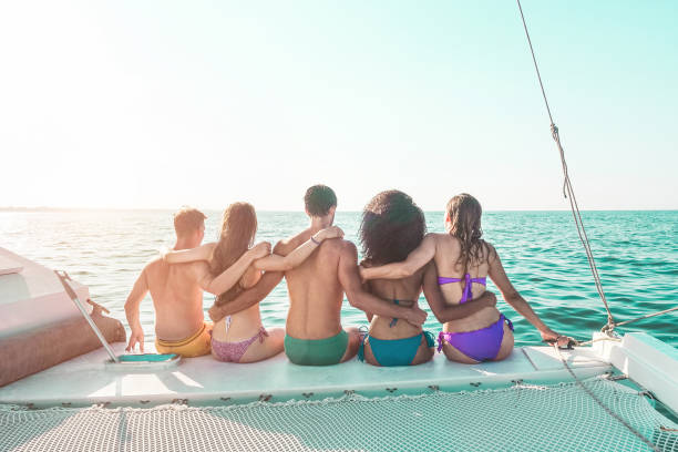 Happy young friends chilling in catamaran boat - Relaxed people making ocean caribbean tour - Travel lifestyle, summer, friendship, tropical concept - Focus on bodies Happy young friends chilling in catamaran boat - Relaxed people making ocean caribbean tour - Travel lifestyle, summer, friendship, tropical concept - Focus on bodies river swimming women water stock pictures, royalty-free photos & images