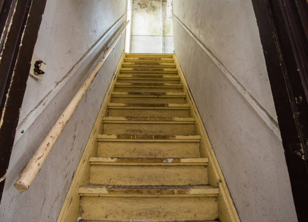 Old dirty damaged abandoned wooden stairs to the garret. Entrance to the attic. Old dirty damaged abandoned wooden stairs to the garret. Entrance to the attic. in the dark interior of old house garret stock pictures, royalty-free photos & images