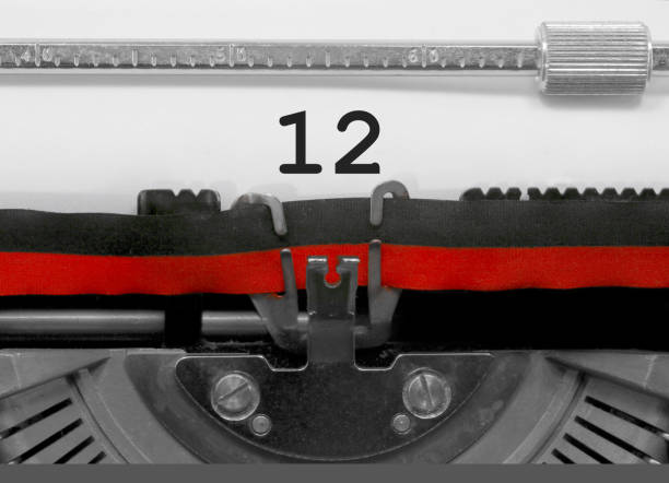 istock 12 Number by the old typewriter on white paper 960539582