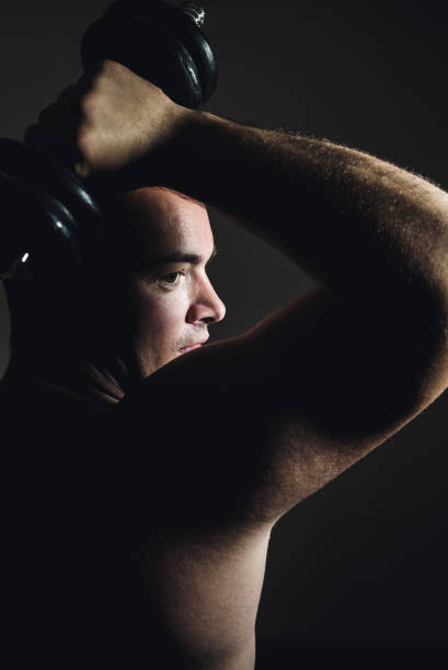 istock Caucasian man holding dumbbells 960540294