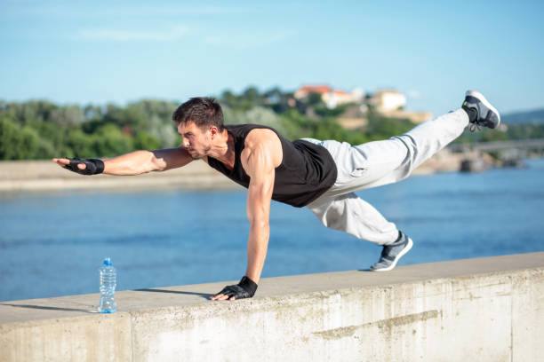 istock Determined young man working out on the riverbank 960551262