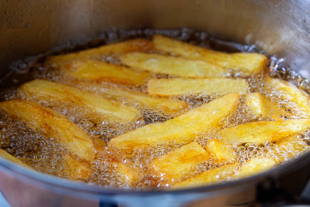 French fries french fries in boiling oil. Fried potatoes. Fat and tasty food. Fast food