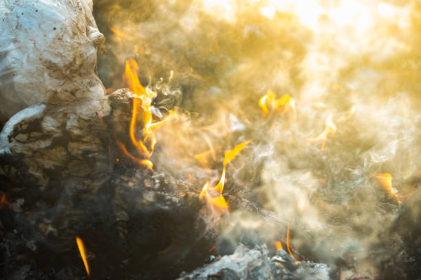 fire and smoke burning garbage pile to air pollution