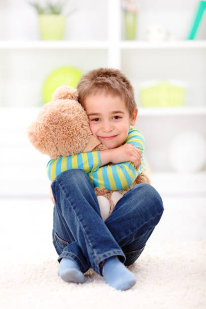 istock Little boy loving his plush bear 960559982