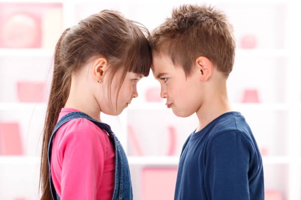 istock Angry kids looking at each other 960560788