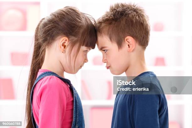 Angry Kids Looking At Each Other Stock Photo - Download Image Now - Child, Arguing, Conflict