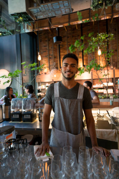 istock Happy waiter working at a restaurant behind the bar 960567966