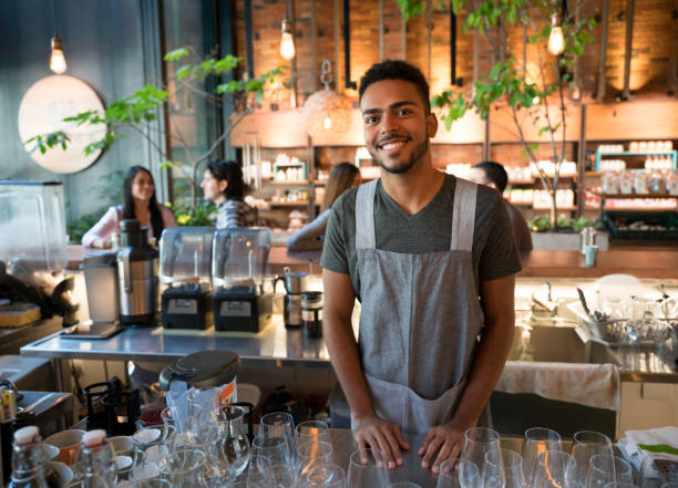 istock Happy man working at a restaurant behind the bar 960567982