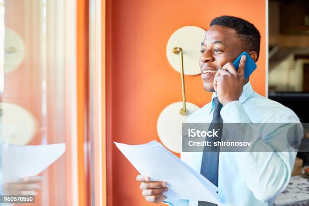 Working With Client By Phone Stock Photo - Download Image Now - Using Phone, African-American Ethnicity, Bank Manager