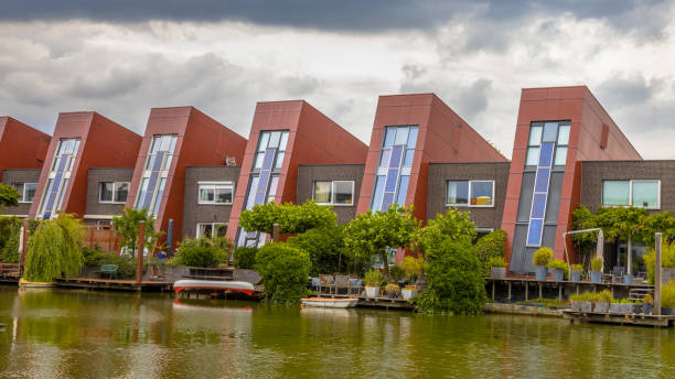 Ecological houses with vertical gardens Waterfront houses with integrated solar panels and hanging gardens on waterfront in urban area of The Hague, Netherlands dutch architecture stock pictures, royalty-free photos & images