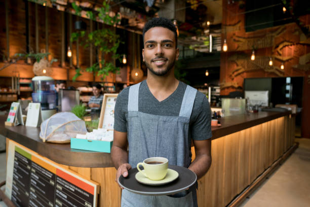 istock Waiter serving a cup of coffee at a cafe 960576268