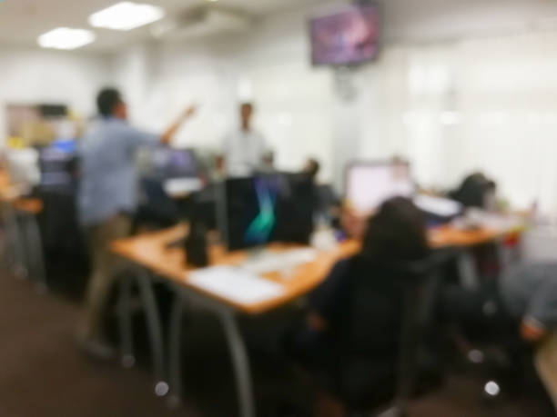 istock blurred in the office work space of table work in office with computer and asian people now working., using for business concept. 960579188