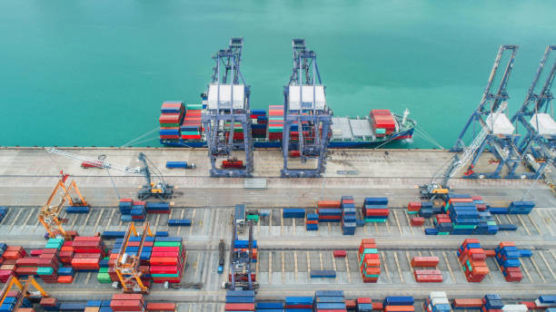 istock Container ship in export and import business and logistics. Shipping cargo to harbor by crane. Water transport International. Aerial view and top view 960583454