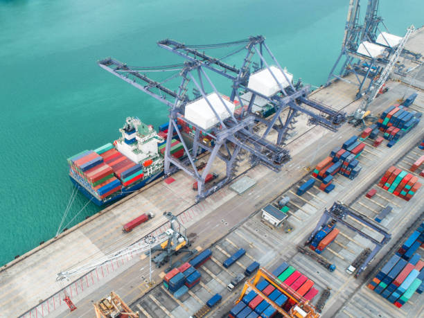 istock Container ship in export and import business and logistics. Shipping cargo to harbor by crane. Water transport International. Aerial view and top view 960583466