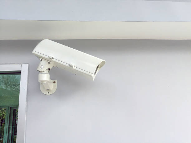 istock White CCTV Camera on the white wall., cctv camera in factory office. security concept. 960586188