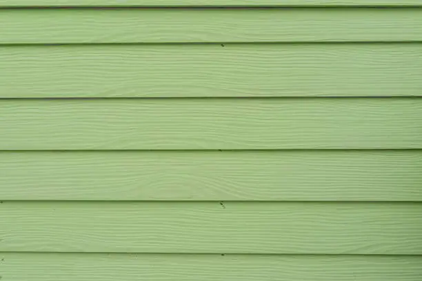 Green mint color wood barn. Woodboard background.