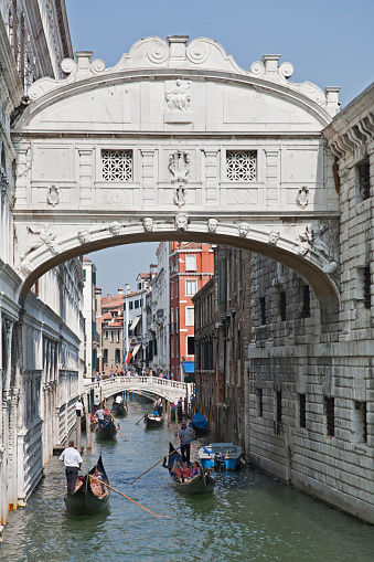September 9, 2014: Venice, Italy- The landmark limestone Bridge of Sighs with tourists, people in gondola taxis