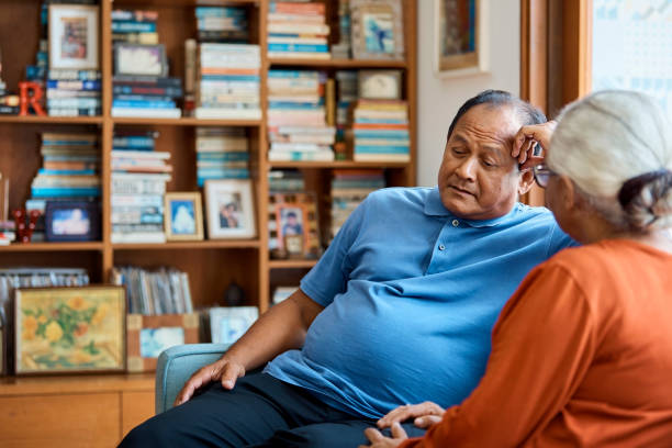 istock Thoughtful senior man sitting by woman on sofa 960594796