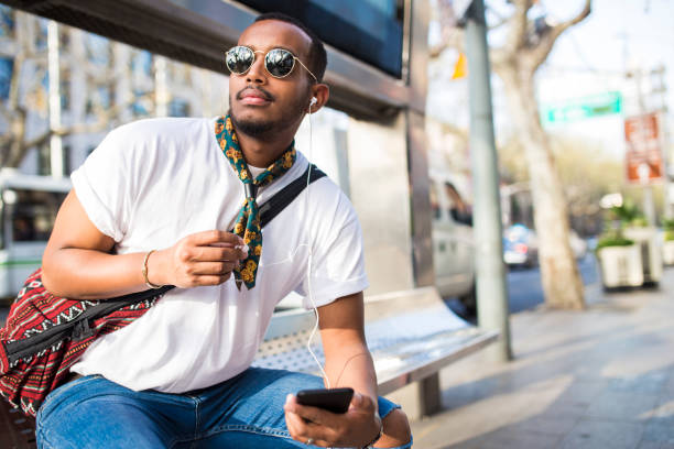istock Young mixed race man waiting for the bus. 960598036