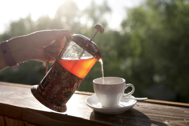 istock Person pouring tea from french press 960600818