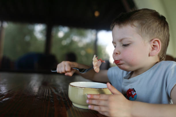 istock Boy eating vareniki 960600938