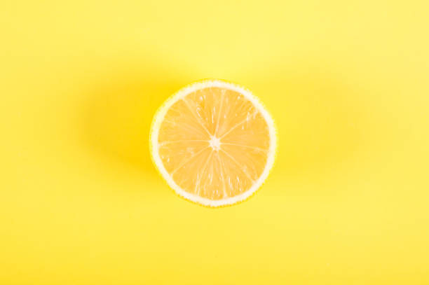 istock Half of lemon on a yellow background 960601630