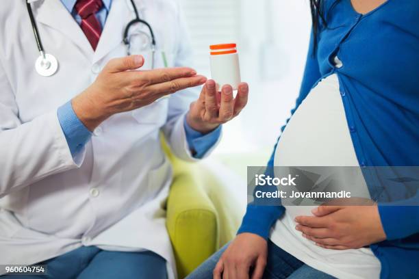 Close Up Of Doctors Who Recommend Vitamin To Pregnant Women Stock Photo - Download Image Now
