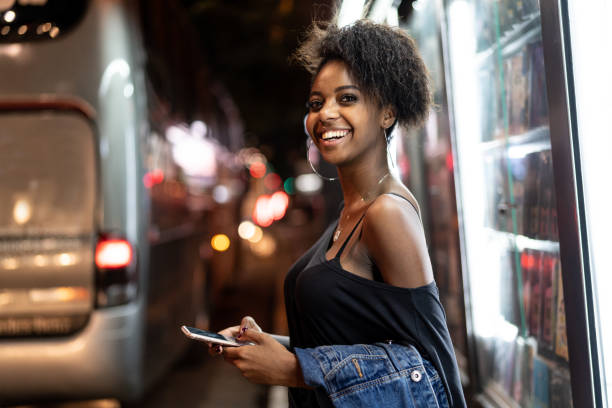 istock Young black woman using mobile in urban background 960617554